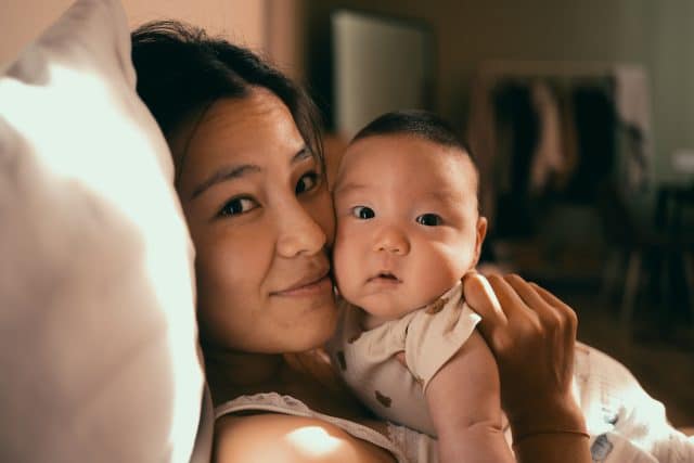 Cute baby with mother smiling
